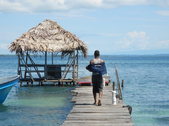 Man walking on dock, Bocas del Toro island visit 2012, Jacy Woodruff, Peace Corps Panama